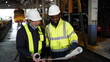 © FotoArtist - Engineers in discussion in machine maintenance in factory. Industrial Engineers with Blueprint against trains and machinaries industry background. Studying Blueprint with Superior