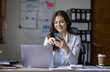 © David - Young business multiethnic women or cheerful Asian lady working onlaptop and using phone at workplace office, financial documents having phone conversation, copy space