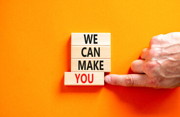 Support and we can make you symbol. Concept words We can make you on wooden blocks. Beautiful orange background. Businessman hand. Business psychological we can make you concept. Copy space