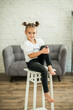 © verzunyna - the girl is sitting on the sofa, beautiful interior, white blouse