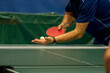 table tennis player serving, ball is in open hand