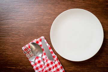 empty plate or dish with knife, fork and spoon