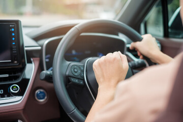 woman driver honking a car during driving on traffic road, hand controlling steering wheel in vehicle. Journey, trip and safety Transportation concepts