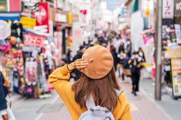 young woman traveler walking on the takeshita street in harajuku the center of teenage fashion and c
