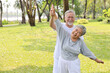 © feeling lucky - Asian senior couple practice yoga excercise, tai chi tranining, stretching and meditation together with relaxation for healthy in park outdoor after retirement. Happy elderly outdoor lifestyle concept