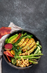 Vegan buddha bowl. Bowl with  vegetables, Zucchini fritters and vegetables chips.