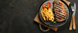 Fototapeta Kawa jest smaczna - Striploin beef steak with french fries on dark background.