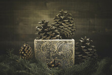 Pine Cones In A Gold Glitter Gift Box On Pine Branches. Christmas Still Life.