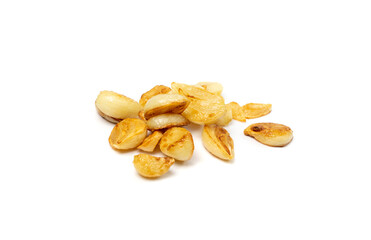 Fried garlic cloves pile closeup isolated. Roasted grilled garlic clove group on white background top view