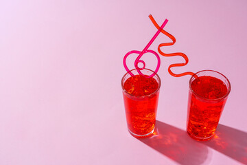 Summer drinks with straws on color background