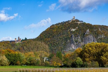 Poster - Drachenfels hill in distance with two medieval castles on it on an autumn day