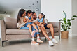 © Beaunitta V W/peopleimages.com - Mother, father and children laughing on sofa together, having fun and bond on weekend. Love, affection and multicultural family on couch in living room. Happy parents playing with kids in family home