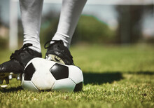 Soccer Player Feet, Deflated Soccer Ball And Sports, Competition Game And Training On Grass Field, Pitch And Lawn. Closeup Footballer Boots Puncture, Broken And Decrease Air Problem Of Flat Equipment