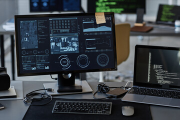 Wall Mural - Background image of several computer screens with data and control panels on desk in IT company office