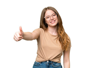 young pretty woman over isolated background with thumbs up because something good has happened