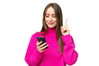© luismolinero - Young beautiful caucasian woman over isolated background using mobile phone and lifting finger