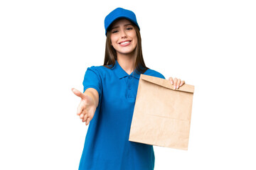 Young beautiful caucasian woman taking a bag of takeaway food over isolated background shaking hands for closing a good deal