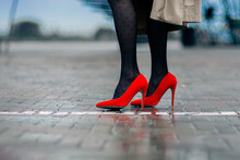 Fashionable Red Women's Shoes On A High Thin Heel With Fashionable Black Tights.