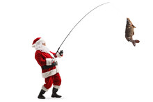 Full Length Profile Shot Of Santa Claus With A Carp Fish On A Fishing Rod