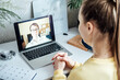 © irissca - Young woman student applicant having online virtual video call job interview meeting with female hr recruiter or employer. Distance remote recruitment conference chat