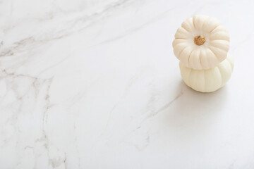 Wall Mural - white pumpkins on white marble background