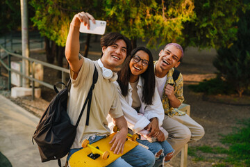 Wall Mural - Three multiracial friends taking selfie photo in skate park