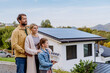 © Halfpoint - Happy family holding paper model of house with solar panels.Alternative energy, saving resources and sustainable lifestyle concept.