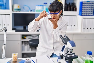 Canvas Print - Young woman scientist holding sample at laboratory