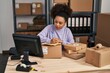 © Krakenimages.com - Young african american woman writing on package at office