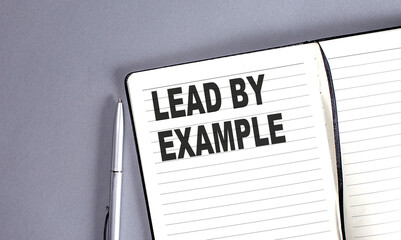 lead by example word on the notebook with pen