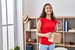 © Krakenimages.com - Young african american woman smiling confident holding package at home