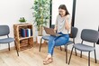 © Krakenimages.com - Young asian nurse woman sitting at waiting room using laptop screaming proud, celebrating victory and success very excited with raised arms