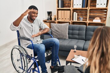 Canvas Print - African american man doing therapy sitting on wheelchair gesturing with hands showing big and large size sign, measure symbol. smiling looking at the camera. measuring concept.