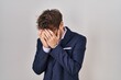 © Krakenimages.com - Hispanic business man wearing glasses with sad expression covering face with hands while crying. depression concept.