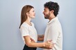 © Krakenimages.com - Young couple wearing casual clothes standing together looking to side, relax profile pose with natural face and confident smile.