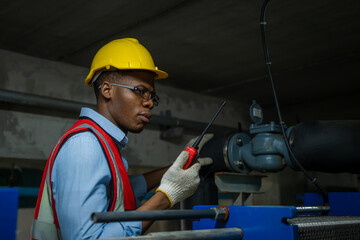 Aufkleber - Worker Inspecting Water Valve For Leaks In Basement of a huge factory.