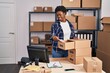 © Krakenimages.com - African american woman ecommerce business worker put document on drawer at office
