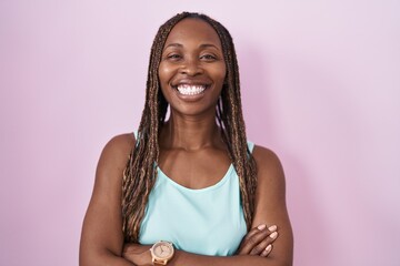 Sticker - African american woman standing over pink background happy face smiling with crossed arms looking at the camera. positive person.