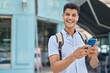 © Krakenimages.com - Young hispanic man student using smartphone at street