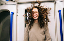 Woman With Wind Swept Hair Traveling In Subway Train