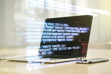 Double exposure of abstract programming language on laptop background, research and development concept