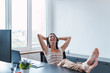 © Westend61 - Relaxed young customer service representative wearing headset relaxing in office