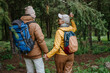 © Westend61 - Senior man holding hands of woman walking together in forest