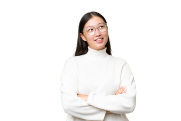 Wall Mural - Young Asian woman over isolated background frightened and pointing to the side