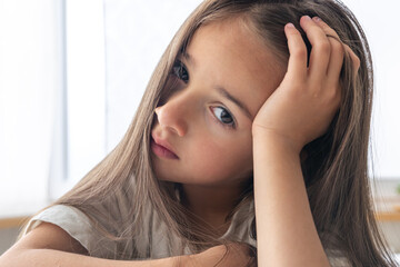 portrait of a charming little girl in bed early in the morning.