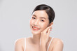 © 220 Selfmade studio - Beautiful Asian young woman touching soft cheek smile with clean and fresh skin Happiness and cheerful with positive emotional isolated on white background. Self care of Beauty and Cosmetics Concept