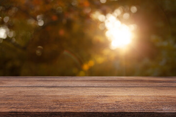 Wall Mural - Wooden table on a natural blurred background