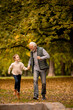 © BGStock72 - Grandfather spending time with his granddaughter in park on autumn day