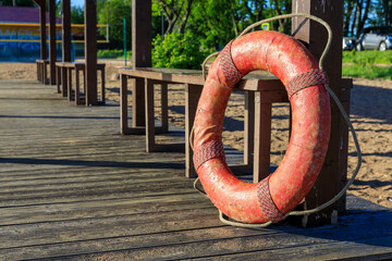 Poster - Red lifebuoy on the beach in summer