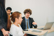 © NewSaetiew - Businesswoman holding a meeting, conference, and conversation with his team while seated in a wheelchair at the workplace.
